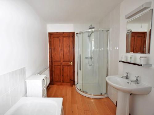a bathroom with a shower and a sink at 3 Bed in New Quay LLWYD in Pencader