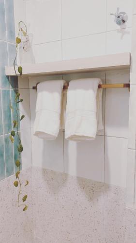 a bathroom with white towels on a shelf at Mersika Beachfront Studio Near To Mersing Jetty in Mersing
