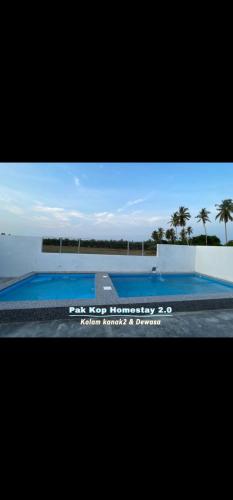 a television screen with a picture of a swimming pool at Pak Kop Homestay with private pool 2 in Parit Buntar