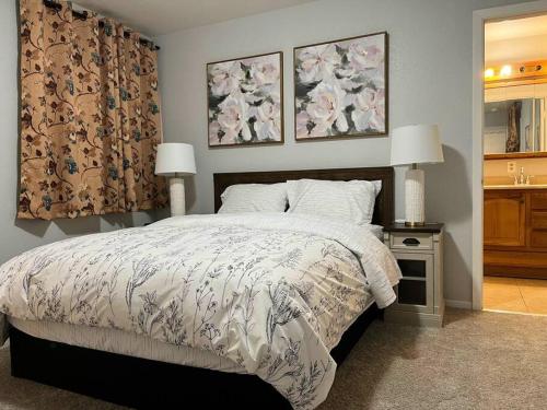 a bedroom with a bed and two pictures on the wall at Spacious 2Beds Suite Close to Downtown and UC Davis Medical Center in Sacramento