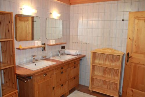 a bathroom with two sinks and a mirror at Schwabenhütte Top 1 in Krimml