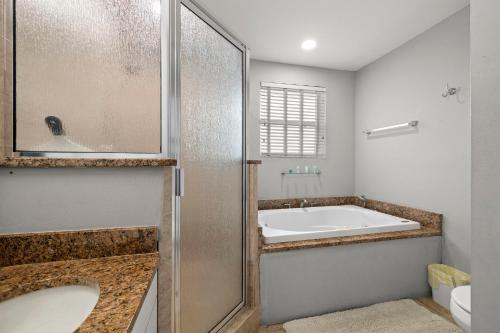 a bathroom with a bath tub and a sink at 1 Bedroom Unit in Hyde Park House in Tampa