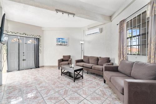 a living room with a couch and a table at Homely 2 bedroom in Morne Rouge