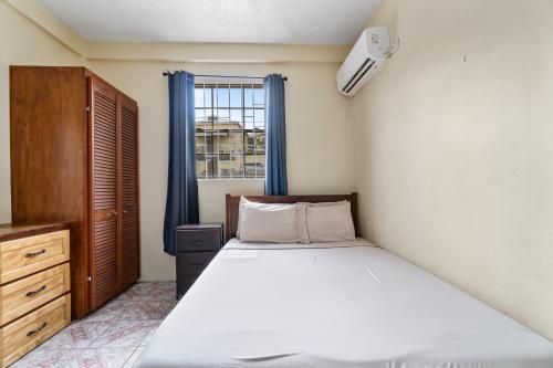 a bedroom with a large bed and a window at Homely 2 bedroom in Morne Rouge