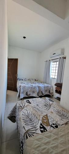 Giường trong phòng chung tại Espaço inteiro - Apto de 1 quarto
