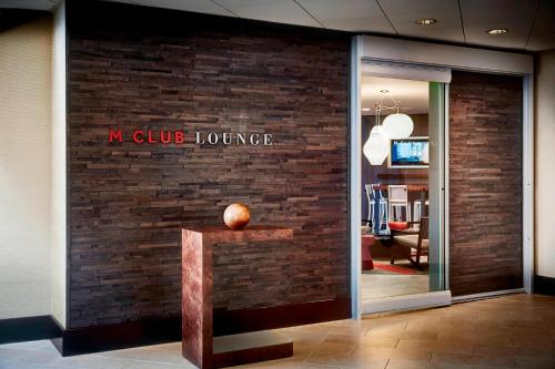 a brick wall with a sign that reads w club lounging at San Francisco Airport Marriott Waterfront in Burlingame
