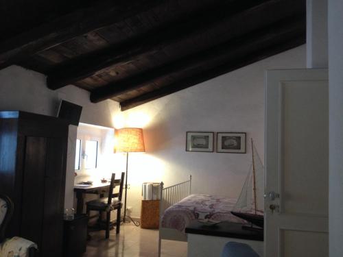 a room with a bed and a table with a lamp at B&B Le Tre Casette in Maratea