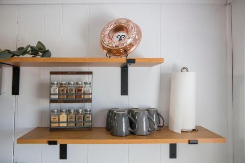 a shelf with bottles of honey and a plate on it at Wayfarer Inn in Dalton