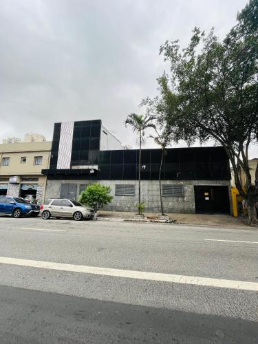 a street with cars parked in front of a building at City Palace in Sao Paulo