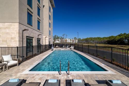 a swimming pool in front of a building at Residence Inn Panama City Beach Pier Park in Panama City Beach