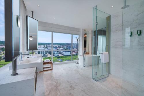 a bathroom with a sink and a glass shower at Fairfield by Marriott Bintulu Paragon in Bintulu