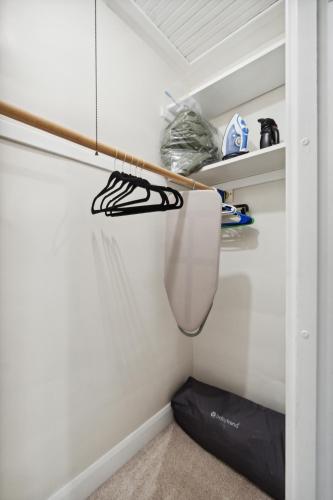 a room with a closet with a shelf and shoes at Exclusive Ottawa Hills Private Home, Garage, WD, Gourmet Equipped kitchen, Netflix in Ottawa Hills