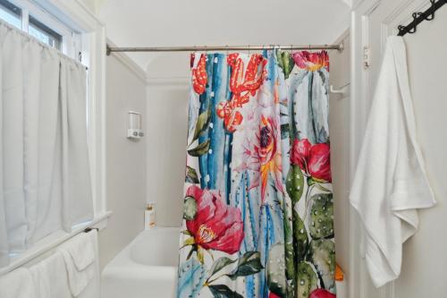a bathroom with a shower curtain with flowers at Exclusive Ottawa Hills Private Home, Garage, WD, Gourmet Equipped kitchen, Netflix in Ottawa Hills