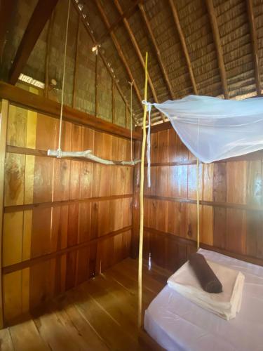 a room with a hammock in a wooden cabin at Lily's Beach Bungalows in Koh Rong Island