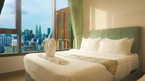 a hotel room with a bed with a view of a city at Lalaport Suites At Lucentia Bukit Bintang City Center in Kuala Lumpur