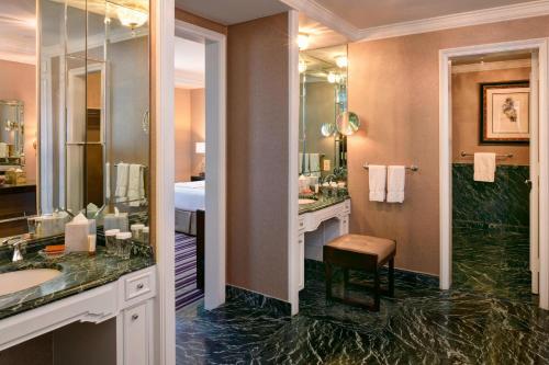a bathroom with two sinks and a large mirror at The Henry, Autograph Collection in Dearborn