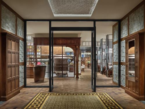 an entrance to a store with glass doors at Rosewood Guangzhou, enjoy free shuttle bus service between the hotel and the Canton Fair Complex during the Canton Fair in Guangzhou