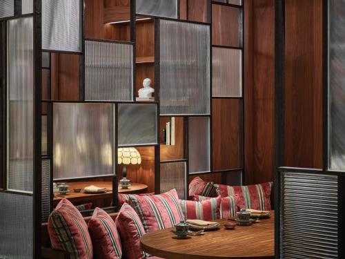 a room with a table and chairs and wooden walls at Rosewood Guangzhou, enjoy free shuttle bus service between the hotel and the Canton Fair Complex during the Canton Fair in Guangzhou