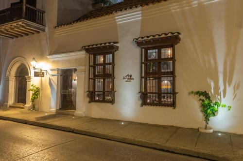 a building with windows on a street at night at Hotel Casa Don Luis by Faranda Boutique, a member of Radisson Individuals in Cartagena de Indias