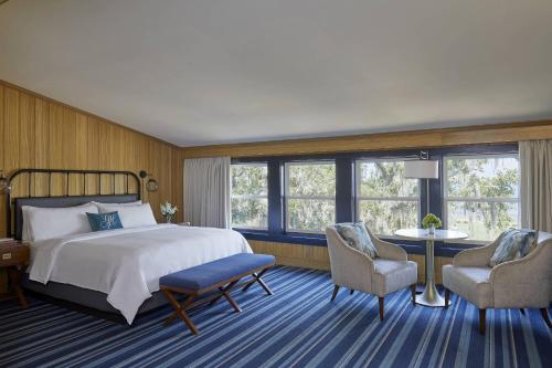 a hotel room with a bed and two chairs at Grand Hotel Golf Resort & Spa, Autograph Collection in Point Clear