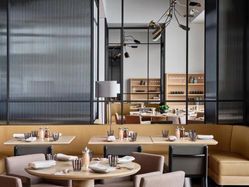 a dining room with tables and chairs and tablesktop at Rosewood Guangzhou, enjoy free shuttle bus service between the hotel and the Canton Fair Complex during the Canton Fair in Guangzhou