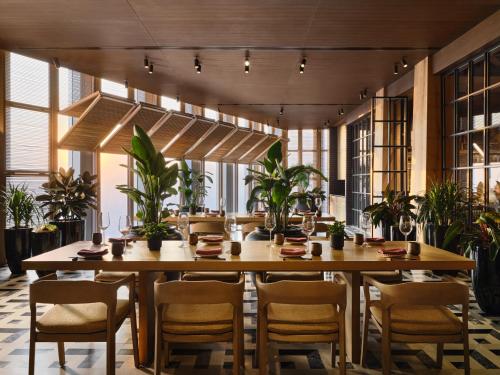a dining room with a large wooden table and chairs at Rosewood Guangzhou, enjoy free shuttle bus service between the hotel and the Canton Fair Complex during the Canton Fair in Guangzhou