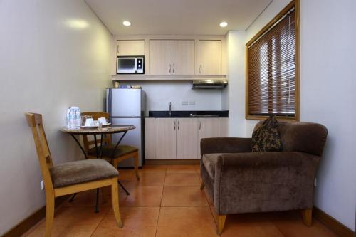 a kitchen with a couch and a table in a room at City Garden Suites Manila in Manila