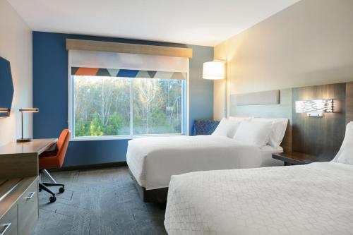 a hotel room with two beds and a window at Holiday Inn Express Apex - Raleigh, an IHG Hotel in Apex
