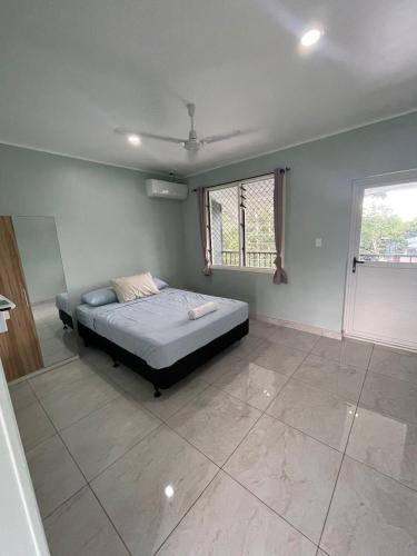 a bedroom with a bed and a window at Moalela'i Accommodation in Apia