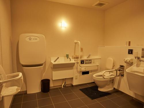 a bathroom with a toilet and a sink at EZ HOTEL Kansai Airport Seaside in Izumi-Sano