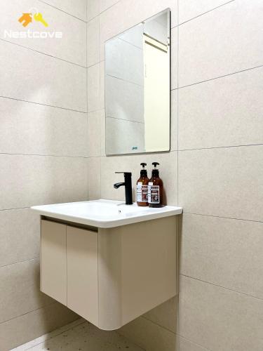 a bathroom with a white sink and a mirror at Costa Mahkota Suites Malacca Central By Nestcove in Melaka