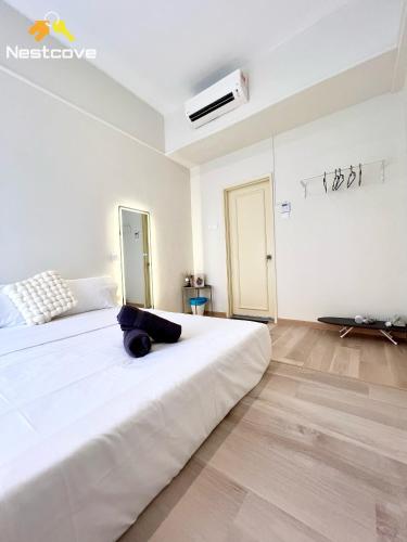a white bedroom with a large white bed in it at Costa Mahkota Suites Malacca Central By Nestcove in Melaka