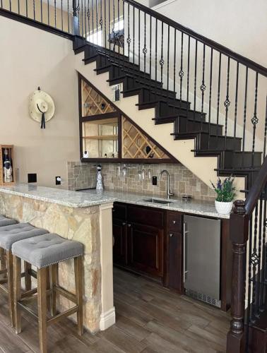 a kitchen with a counter with a sink and a staircase at Spacious Austin Home in Austin
