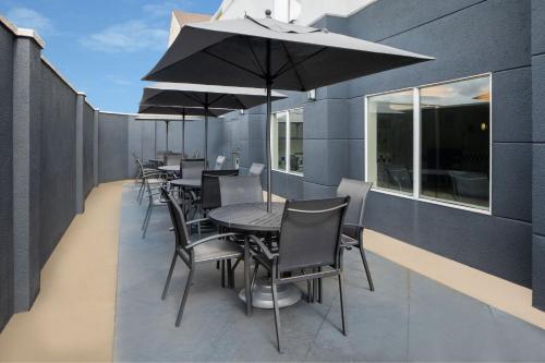 a row of tables and chairs with an umbrella on a balcony at Fairfield Inn and Suites Gulfport / Biloxi in Gulfport