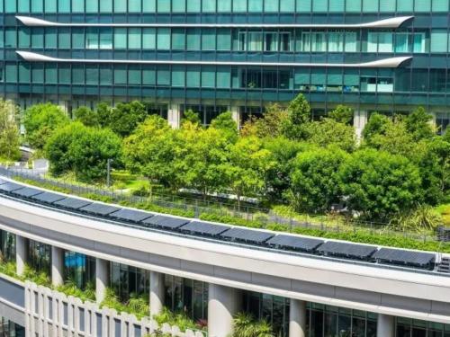 an office building with a road in front of it at EZ HOTEL Kansai Airport Seaside in Izumi-Sano
