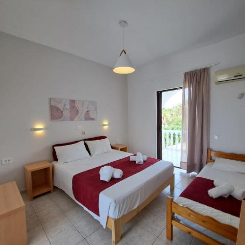 a bedroom with two beds with stuffed animals on them at Studio Stars in Laganas