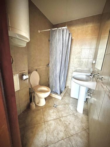 a bathroom with a toilet and a sink at Julia Vigo Panorama apartments in Nesebar