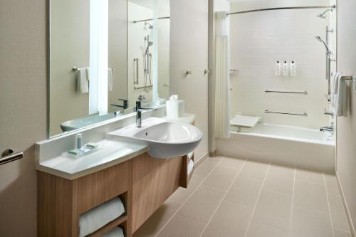 a bathroom with a sink and a shower and a tub at SpringHill Suites by Marriott Arlington TN in Arlington