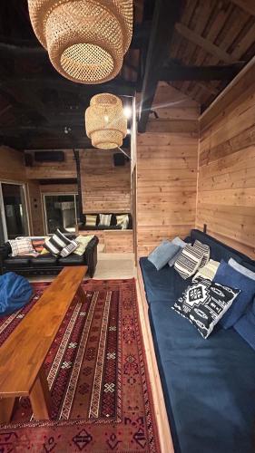 a bedroom with a bed and a table in a room at ケーブキャビン シービュー BBQ ピザ サウナ ホットタブ - Cave Cabin Chiba Seaview BBQ Pizza Sauna Hot-tub in Kobama