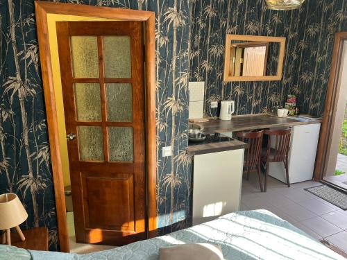 a room with a kitchen with a table and a door at Family House ''Sea side apartments'' in Salacgrīva