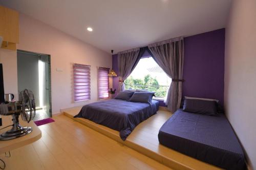 a bedroom with two beds and a window at Yussy X Harvest 29 in Masai