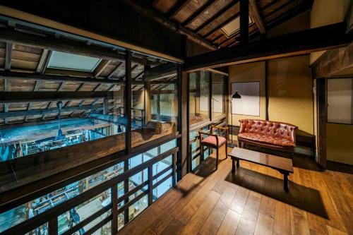 a room with a pool with a couch and a table at Nishijin Isa Machiya Holiday House in Nishijin
