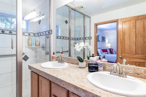 a bathroom with two sinks and a large mirror at Cross Creek - Pool and Hot Tubs by Daniel in Frisco