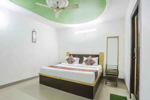 1 dormitorio con 1 cama y ventilador de techo en FabHotel BR International en Agra