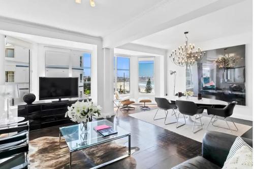 a living room with a table and a tv at Bondi Beachfront Retreat - Beach views in Sydney