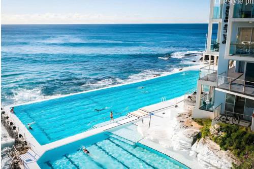 an overhead view of a swimming pool next to the ocean at Bondi Beachfront Retreat - Beach views in Sydney