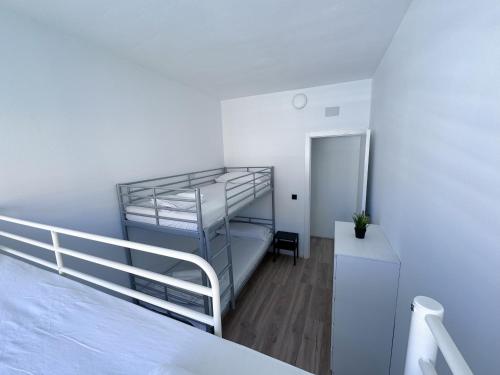 a small bedroom with a bunk bed and a desk at Los Alcores 2.0 in Torremolinos