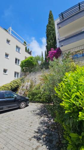 a car parked in front of a building at Residence Alpha Apartments in Cavtat