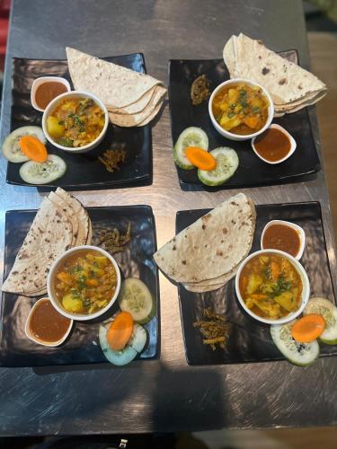 a table topped with three plates of food with soup at Mountain View cafe in Pokhara