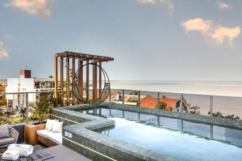 a pool on the balcony of a building with the beach at Way Bossa by Solis in João Pessoa